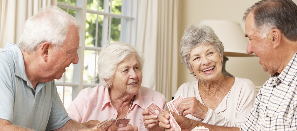 Group Of Senior Couples Enjoying Game Of Cards